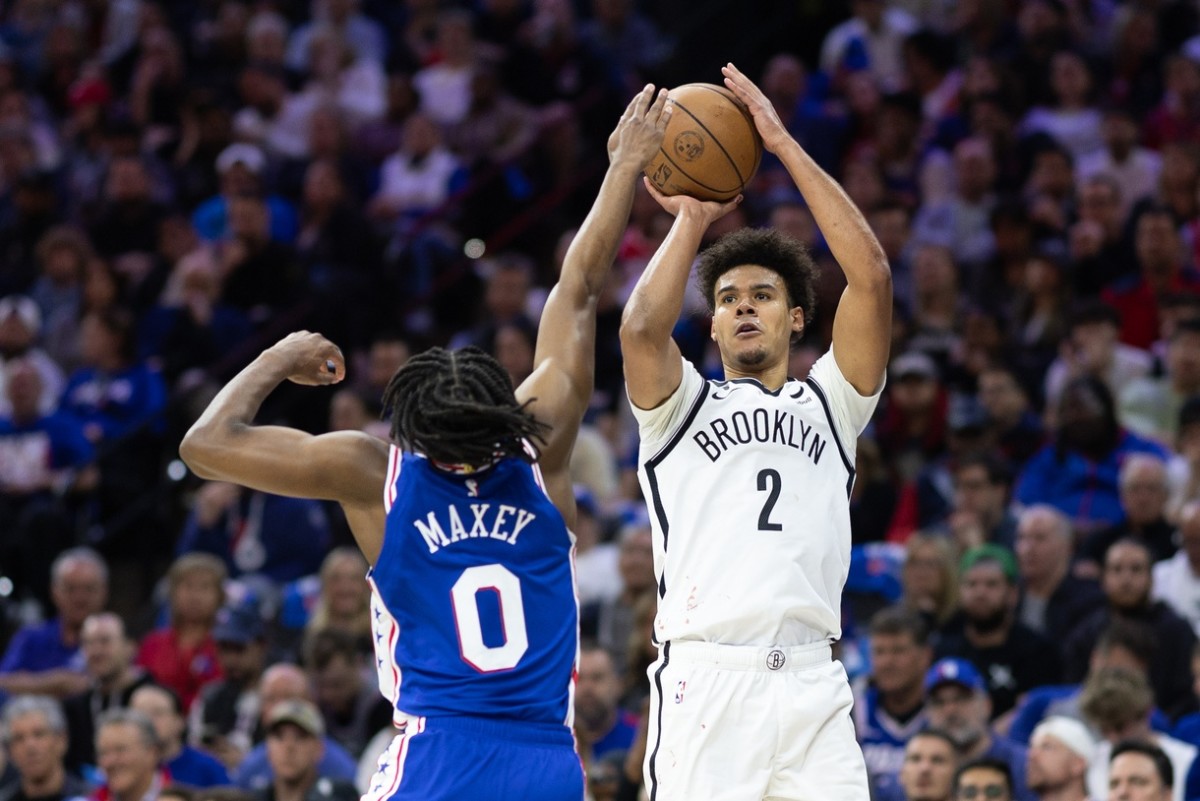 76ers guard Tyrese Maxey defending against Nets' Cam Johnson.