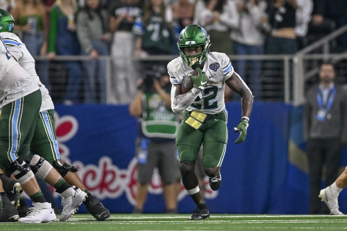 Jan 2, 2023; Tulane Green Wave running back Tyjae Spears (22) runs the ball against the USC Trojans during the 2023 Cotton Bowl. Mandatory Credit: Jerome Miron-USA TODAY Sports