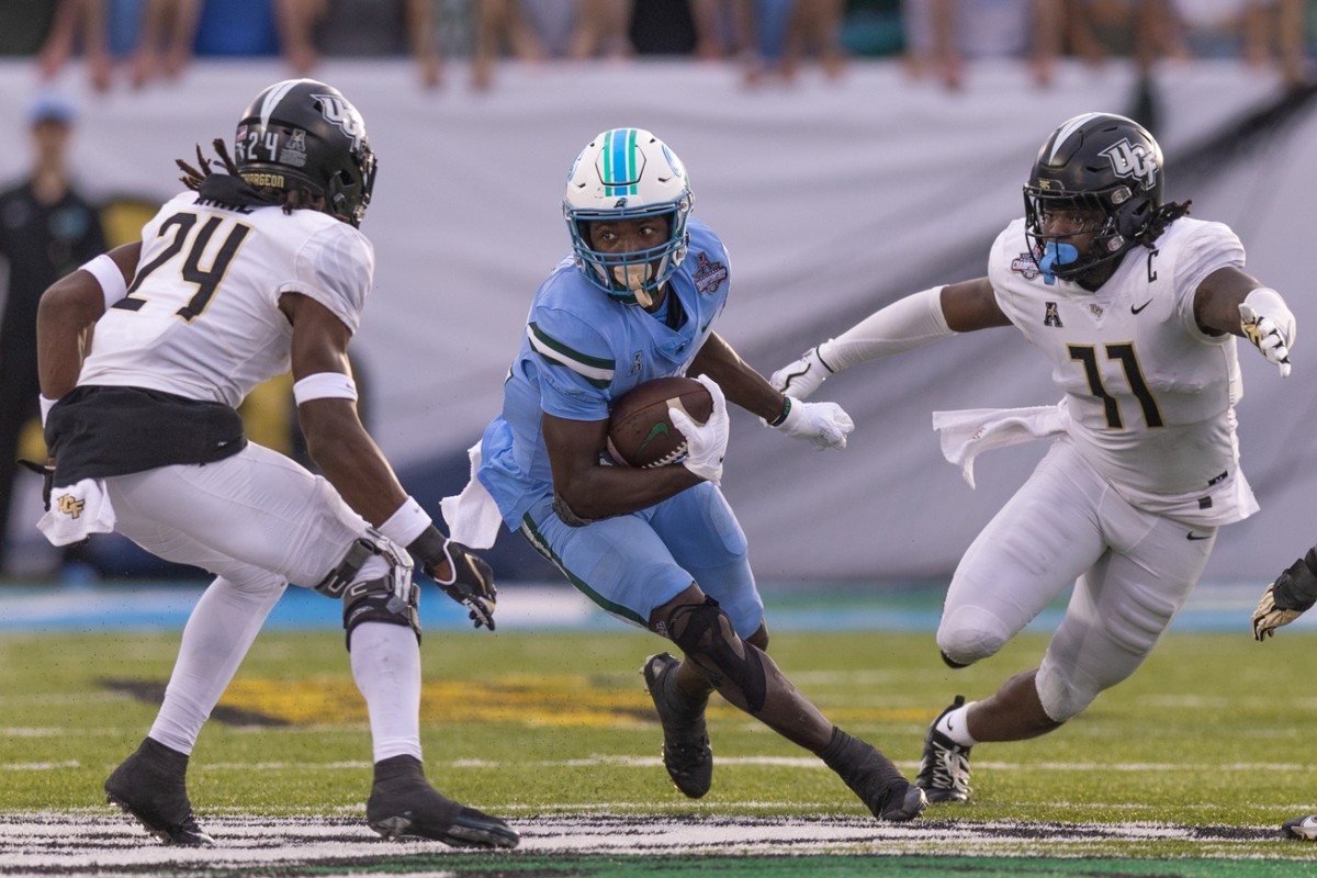 Dec 3, 2022; Tulane Green Wave running back Tyjae Spears (22) rushes against UCF Knights defenders back Jarvis Ware (24) and Jeremiah Jean-Baptiste (11). Mandatory Credit: Stephen Lew-USA TODAY