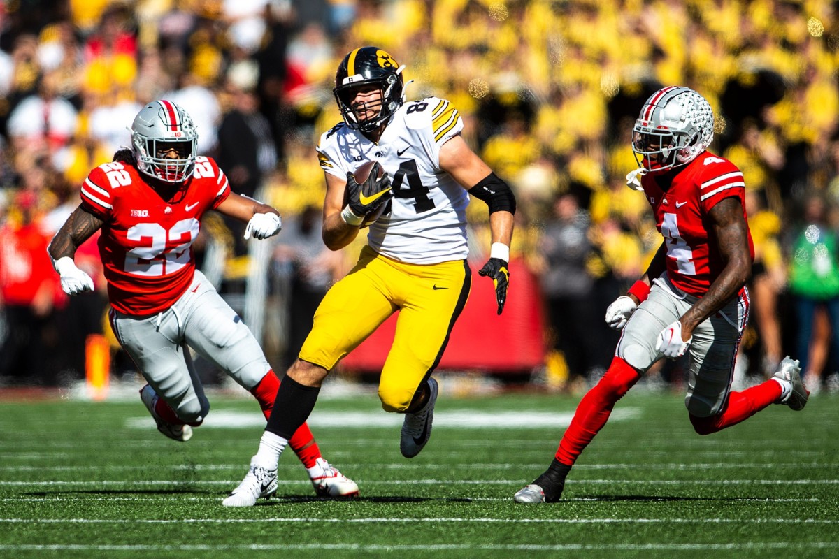 Iowa tight end Sam LaPorta (84) runs after a catch as Ohio State linebacker Steele Chambers (22) and Ohio State cornerback JK Johnson (4) give chase. Joseph Cress/Iowa City Press-Citizen / USA TODAY NETWORK