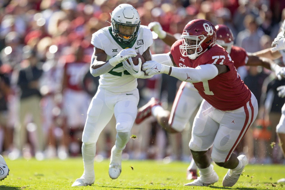 Baylor s Richard Reese (29) runs the ball and is brought down by Oklahoma s Jeffery Johnson (77) in the first quarter of the Bears' 38-35 win Saturday in Norman. tramel -- jump