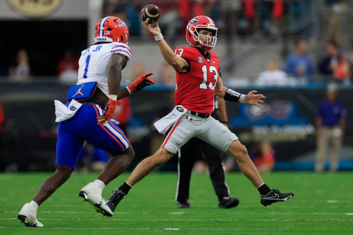 Georgia Bulldogs quarterback Stetson Bennett (13) throws the ball past Florida Gators linebacker Brenton Cox Jr. (1) during the second quarter of an NCAA football game Saturday, Oct. 29, 2022 at TIAA Bank Field in Jacksonville. [Corey Perrine/Florida Times-Union] Flgai 102922 Florida Vs Georgia 04