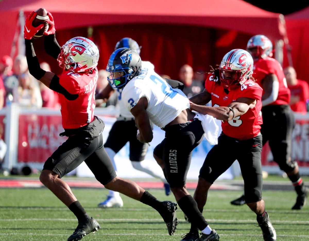 Western defensive back Kahlef Hailassie (12) intercepts the ball intended for MTSU wide receiver Izaiah Gathings (2) as he looks on and Western defensive end Michael Pitts (43) holds him back on Saturday, Nov. 6, 2021, at Houchens-Smith Stadium, in Bowling Green, Ky. 17 Mtsu V Western