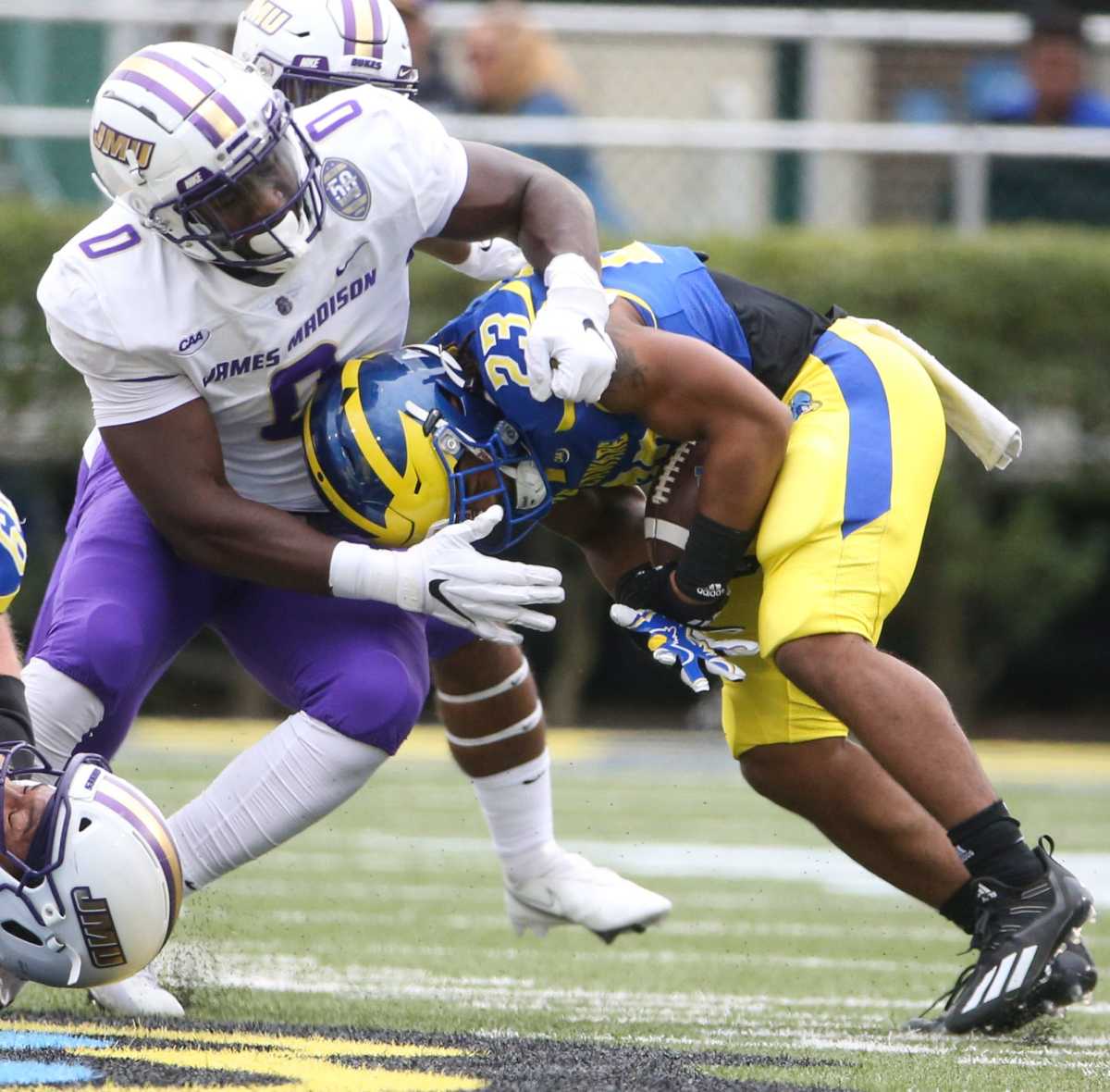 James Madison defensive lineman Isaac Ukwu stops Delaware running back Quincy Watson in the first quarter at Delaware Stadium, Saturday, Oct. 23, 2021. Ud V Jmu