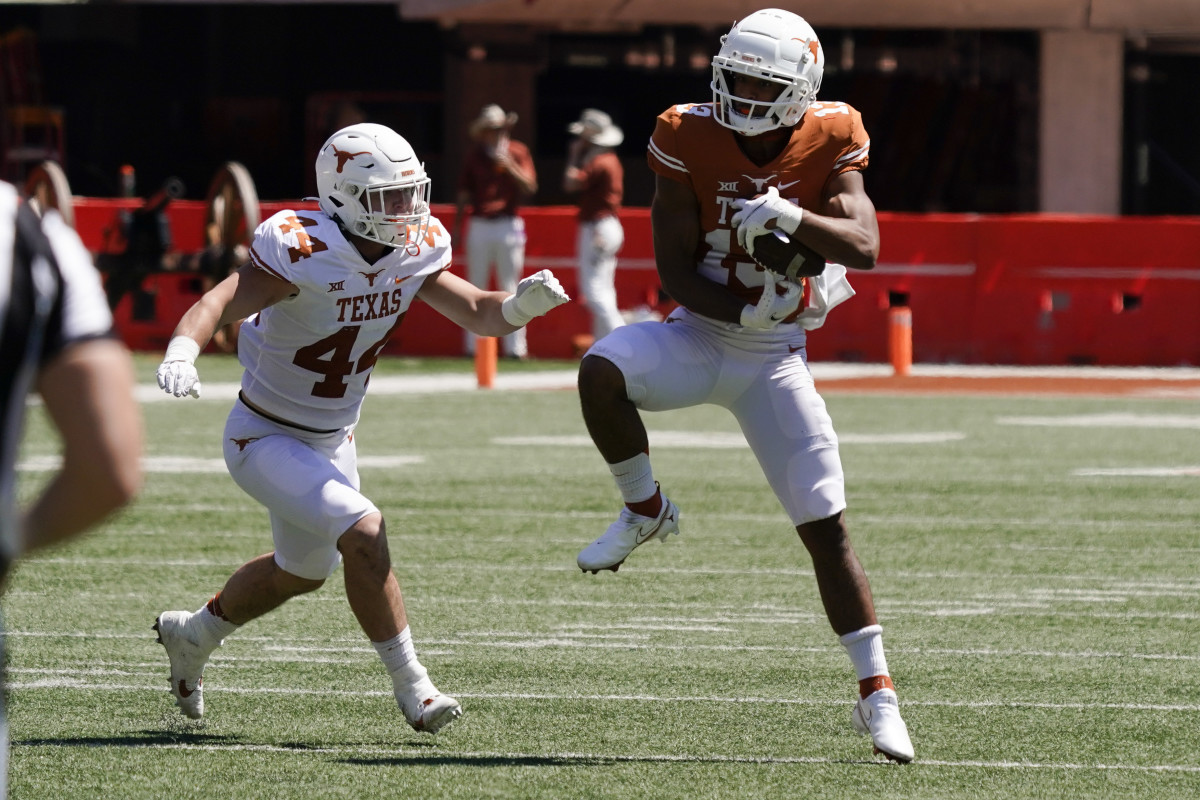 Apr 24, 2021; Austin, Texas, USA; Texas Longhorns Orange wide receiver Jaden Alexis (13) makes a catch as Texas Longhorns White defensive back Tannahill Love (44) defends during the fourth quarter at the Orange-White Texas Spring Game at Darrell K Royal-Texas Memorial Stadium. Mandatory Credit: Scott Wachter-USA TODAY Sports