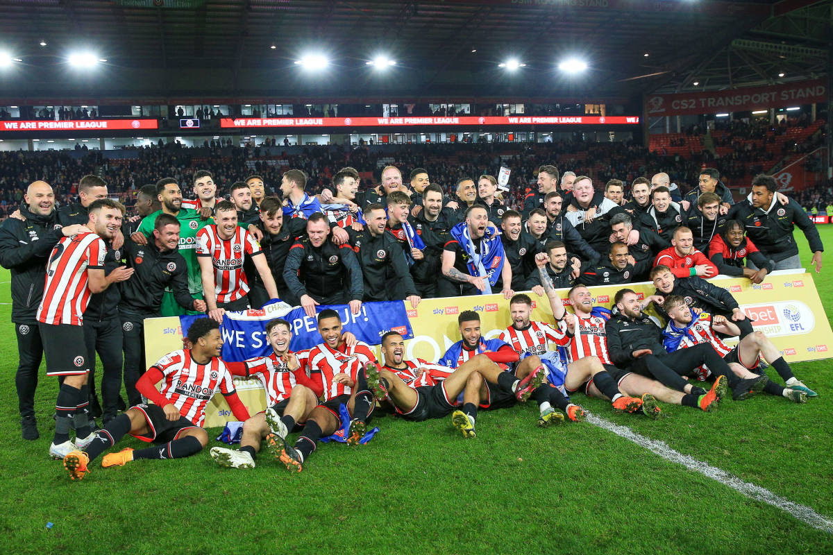 Players and staff from Sheffield United pictured celebrating after sealing promotion from the EFL Championship to the Premier League in 2023