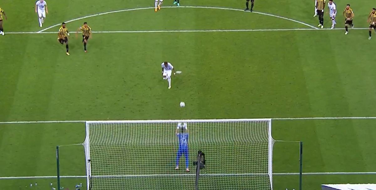 Al-Ittihad goalkeeper Marcelo Grohe pictured standing up to save an attempted Panenka-style penalty kick from Al-Shabab striker Aaron Boupendza during a Saudi Pro League game in April 2023