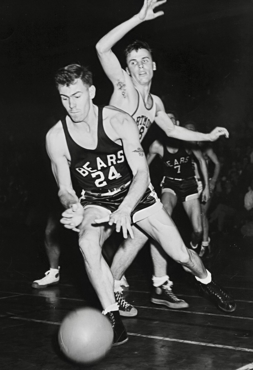 Andy Wolfe dribbles past a defender.