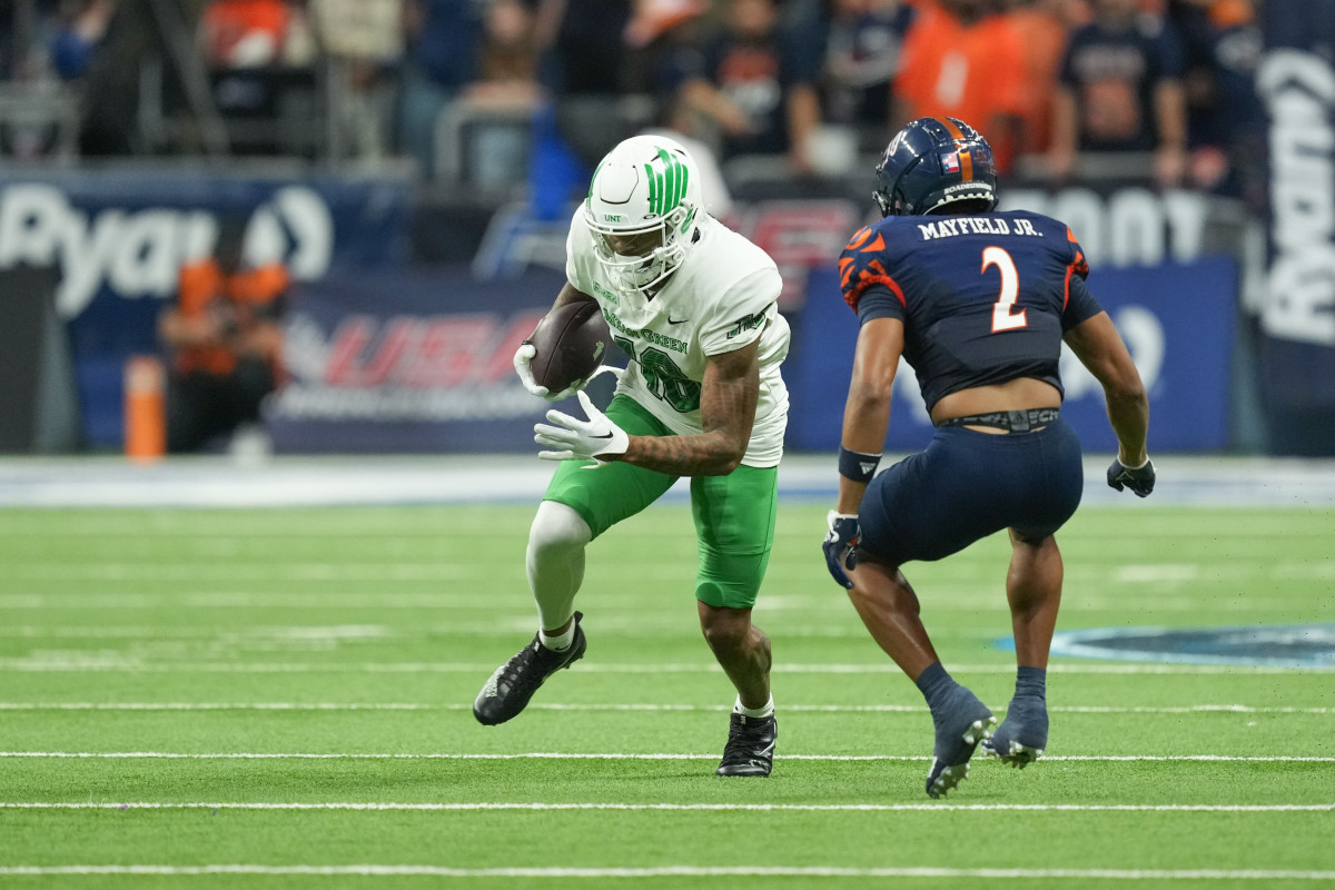 Dec 2, 2022; San Antonio, Texas, USA; North Texas Mean Green wide receiver Jyaire Shorter (16) runs the ball in front of UTSA Roadrunners wide receiver Joshua Cephus (2) in the second half at the Alamodome. Mandatory Credit: Daniel Dunn-USA TODAY Sports