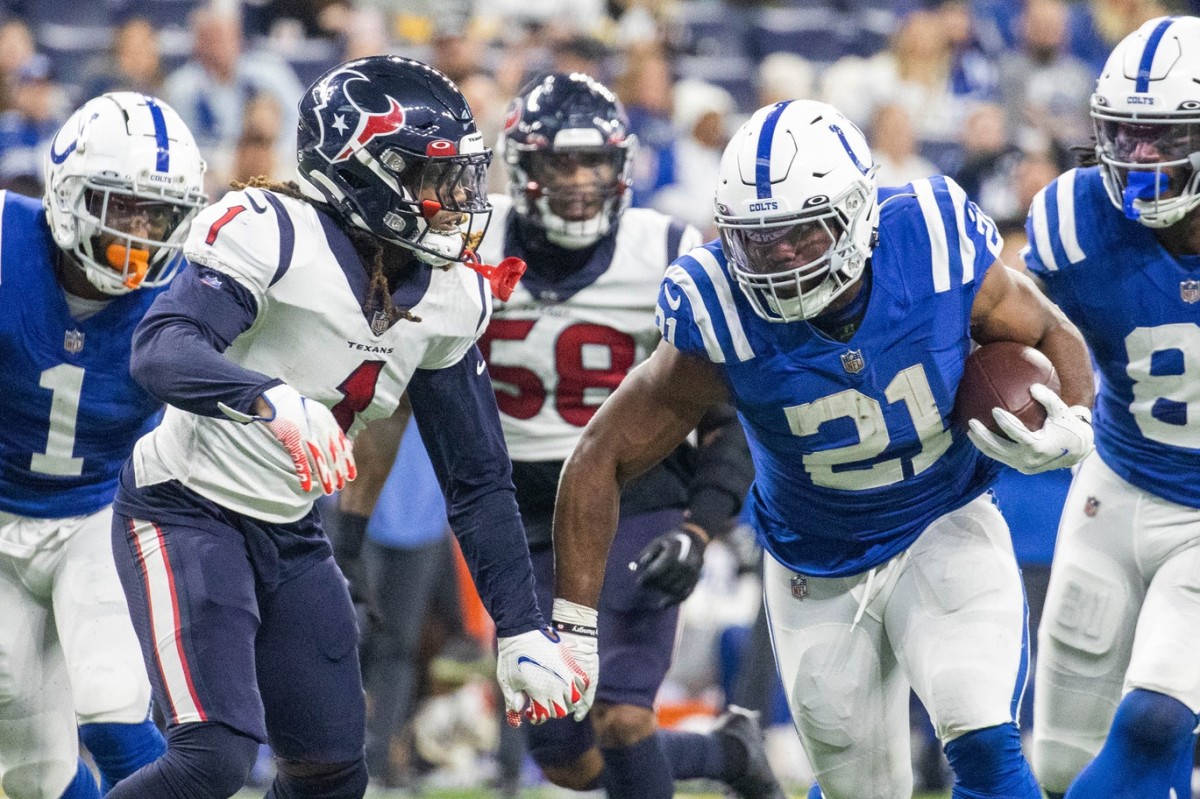 Jan 8, 2023; Indianapolis, Indiana, USA; Indianapolis Colts running back Zack Moss (21) runs the ball while Houston Texans cornerback Tremon Smith (1) defends in the third quarter at Lucas Oil Stadium.