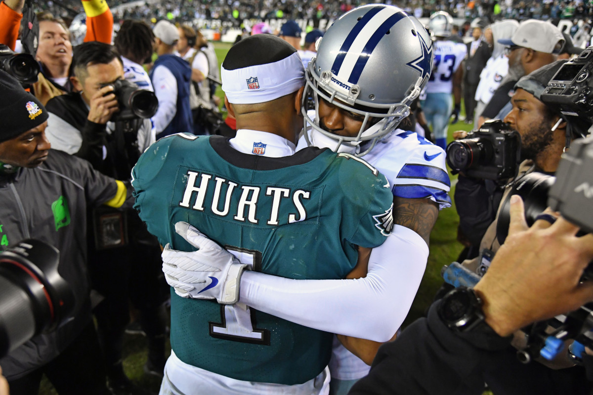 Philadelphia Eagles quarterback Jalen Hurts (1) and ]Dallas Cowboys cornerback Trevon Diggs (7) meat Lincoln Financiaet on the field after the game 2022.