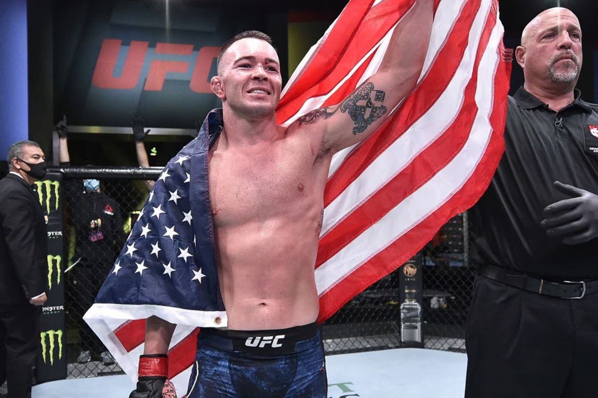 Colby Covington has his arm raised after earning a win at a UFC event.