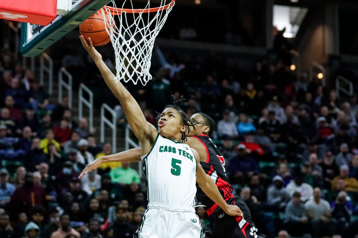 Detroit Cass Tech guard Darius Acuff goes to the basket against Grand Blanc forward Anthony Perdue during overtime of Cass Tech's 62-56 overtime win in the Division 1 semifinal at Breslin Center on Friday, March 24, 2023.