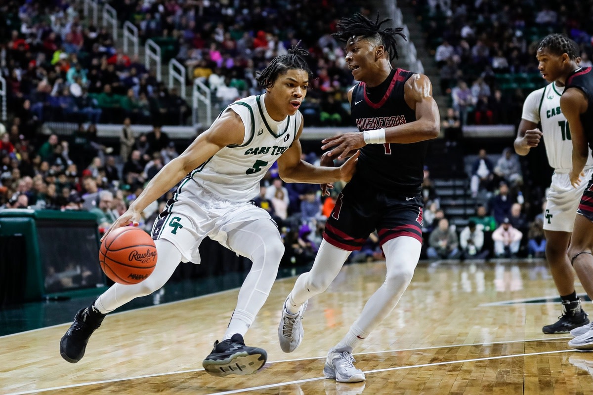 Cass Tech guard Darius Acuff (5) dribbles against Muskegon guard Anthony Sydnor III (4) during the first half of the MHSAA boys Division 1 final at Breslin Center in East Lansing on Saturday, March 25, 2023.