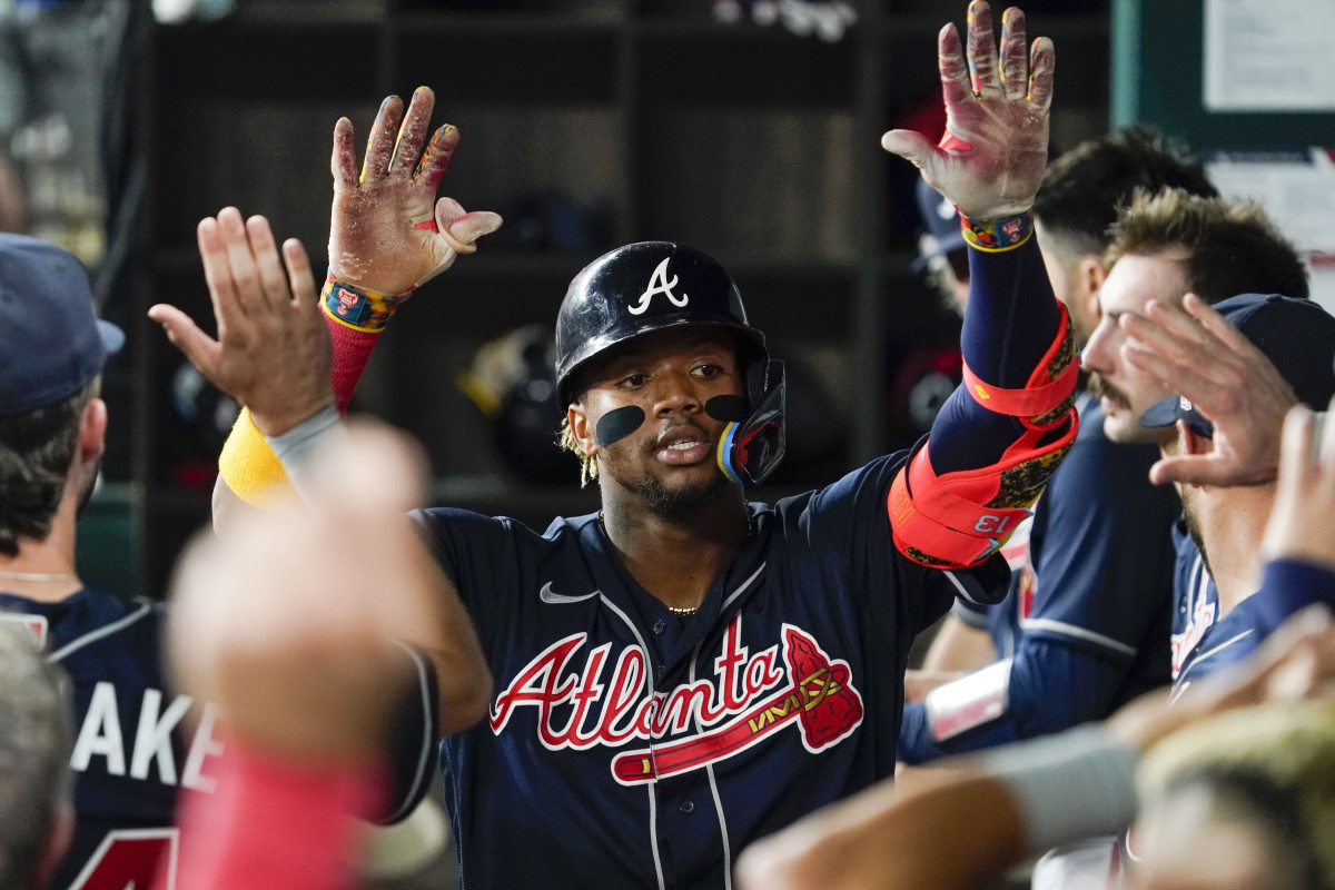 May 17, 2023; Arlington, Texas, USA; Atlanta Braves right fielder Ronald Acuna Jr. (13) is greeted in the dugout after hitting a solo home run against the Texas Rangers during the sixth inning at Globe Life Field. Mandatory Credit: Raymond Carlin III-USA TODAY Sports