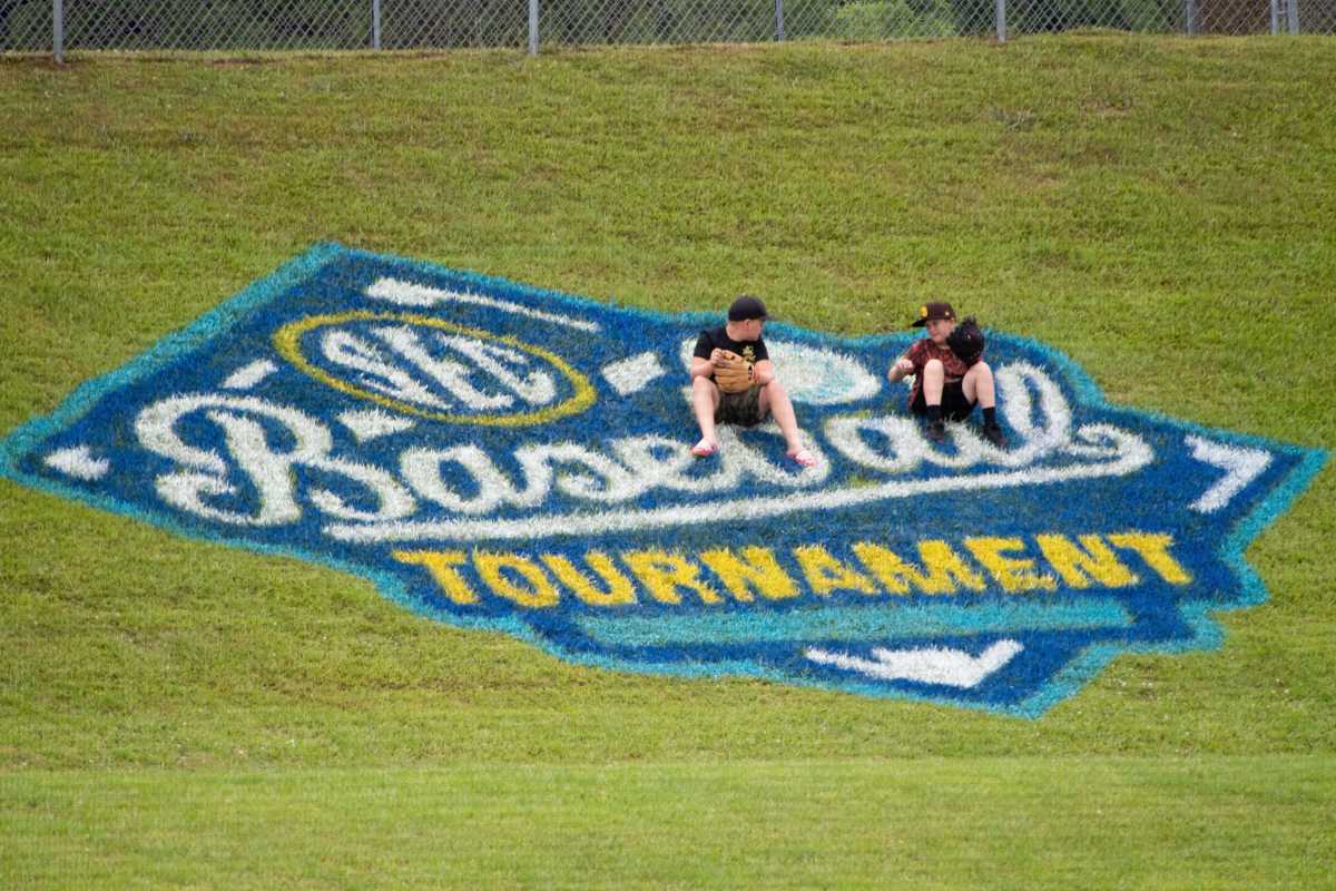May 24, 2022; Hoover, AL, USA; Kids sit on the SEC logo along the left field line as Alabama faced Georgia in game one of the SEC Tournament at Hoover Met.