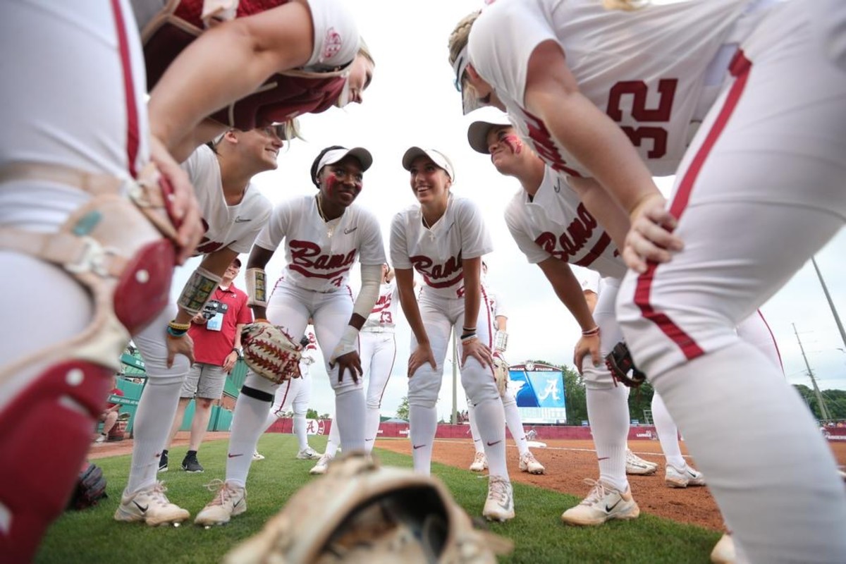 The University of Alabama Softball Team smiles together in huddle against Long Island University at Rhoads Stadium in Tuscaloosa, AL on Friday, May 19, 2023.