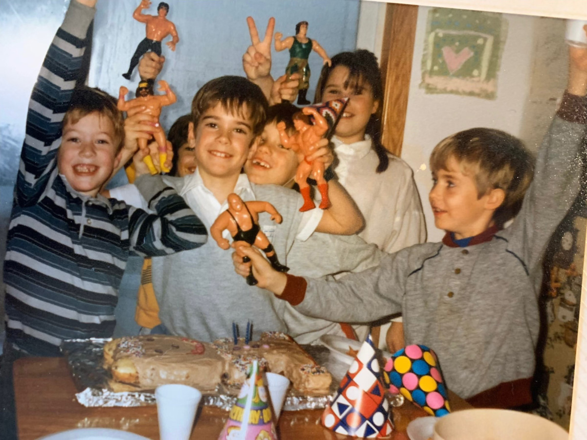 Children holding wrestling action figures