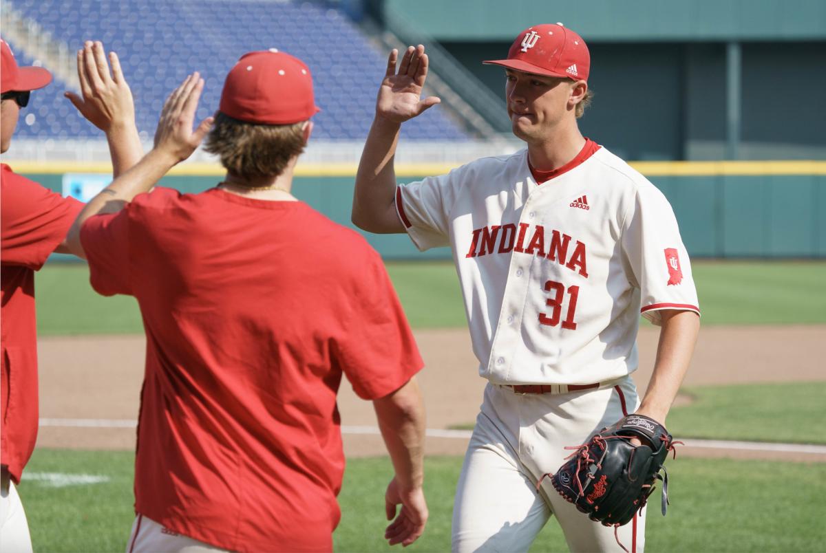 Indiana pitcher Evan Whiteaker (31) gets congratulated after retiring the side in the Hoosiers' 4-3 win over Illinois in the Big Ten Tournament.