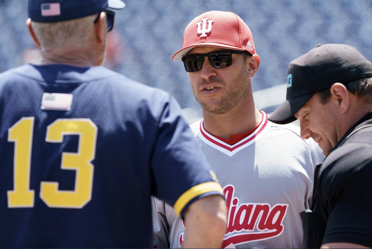 Indiana coach Jeff Mercer chats with Michigan coach Tracy Smith and umpires prior to Friday's game. Smith is a former Indiana coach who went to the College World Series with the Hoosiers in 2013. (Photo courtesy of Big Ten.)