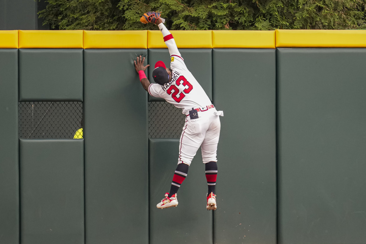 May 28, 2023; Cumberland, Georgia, USA; Atlanta Braves center fielder Michael Harris II (23) makes a catch taking a home run away from Philadelphia Phillies left fielder Kyle Schwarber (12) (not shown) during the second inning at Truist Park.