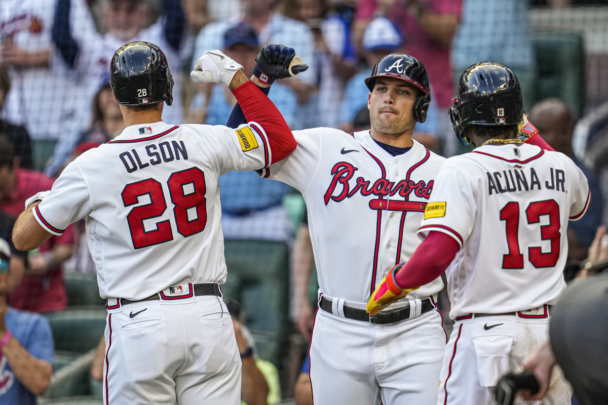 May 28, 2023; Cumberland, Georgia, USA; Atlanta Braves first baseman Matt Olson (28) reacts with third baseman Austin Riley (27) and right fielder Ronald Acuna Jr. (13) after hitting a home run against the Philadelphia Phillies during the first inning at Truist Park.