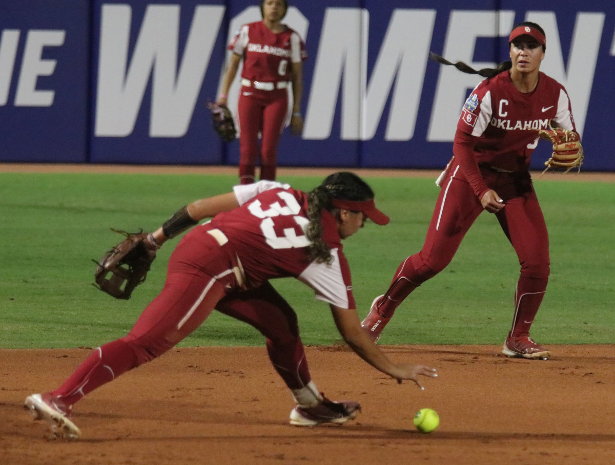 Alyssa Brito gathers the ball off the ground after an error.