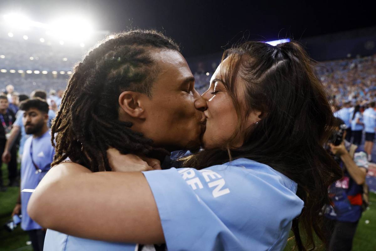 Manchester City defender Nathan Ake pictured sharing a kiss with his wife, Kaylee, after winning the 2023 UEFA Champions League final