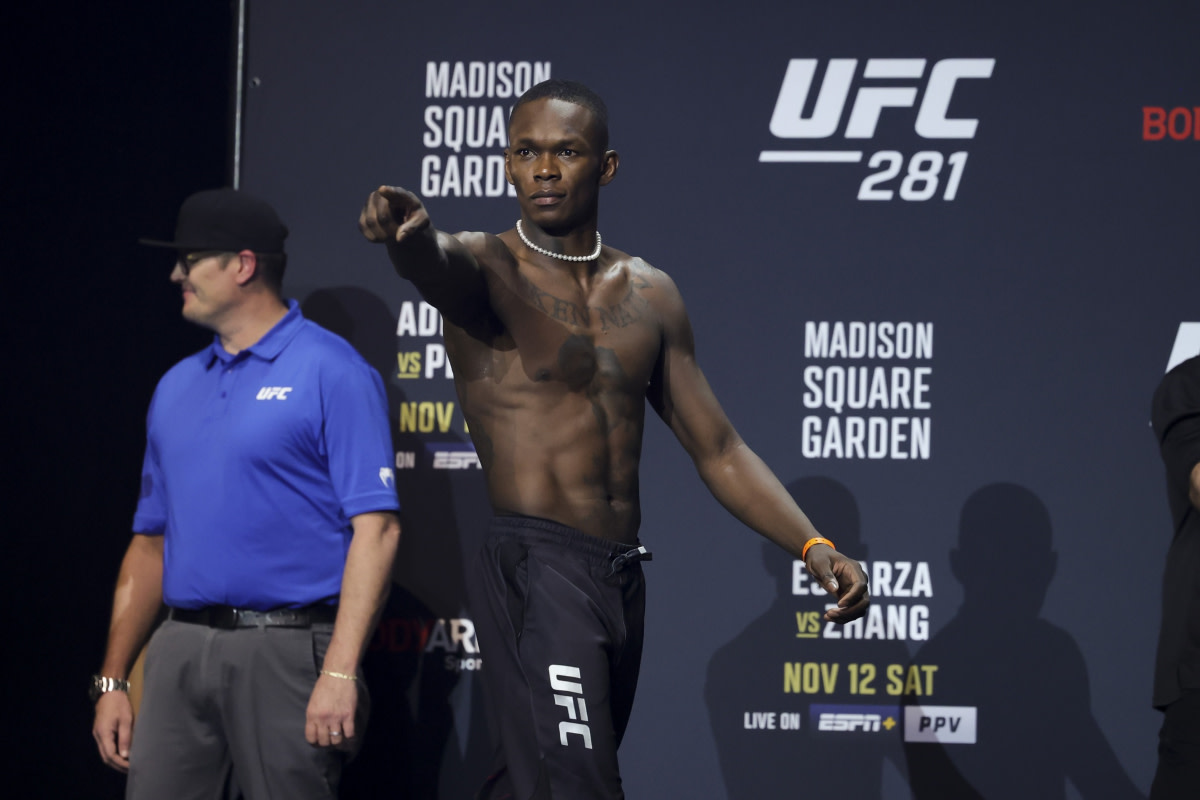 Israel Adesanya hops on the stage for the UFC 281 ceremonial weigh-ins inside Madison Square Garden in New York City.