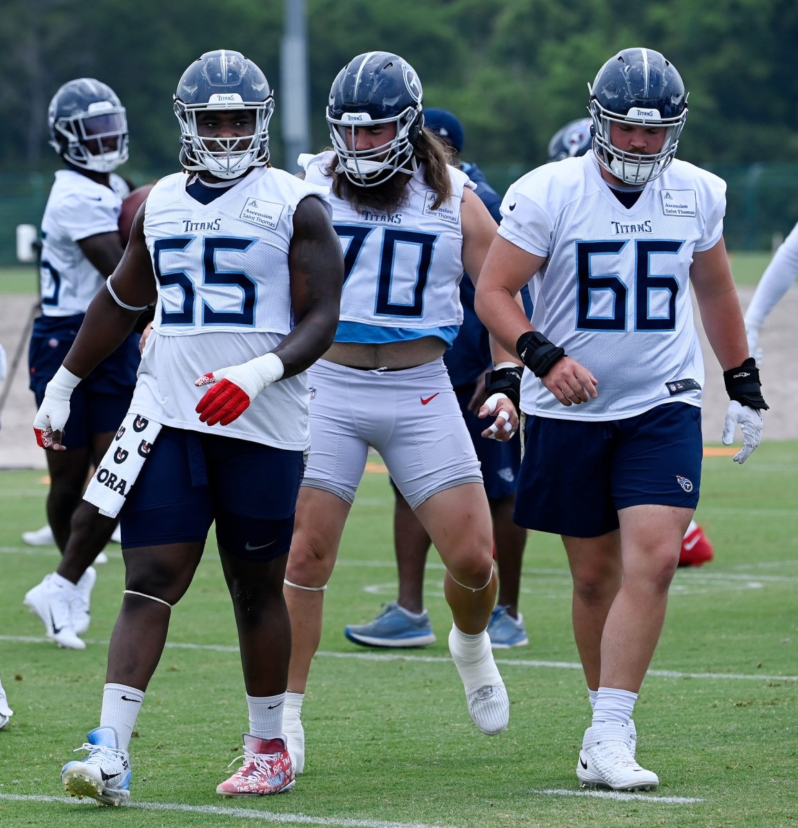 Tennessee Titans Aaron Brewer (55) and James Empey (66) warm up during an NFL football minicamp Wednesday, June 7, 2023, in Nashville, Tenn.