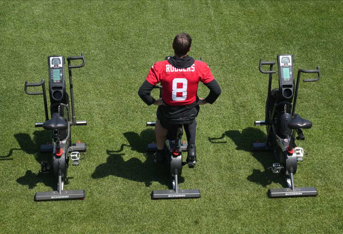 Jets' QB Aaron Rodgers rides the exercise bike at OTAs practice