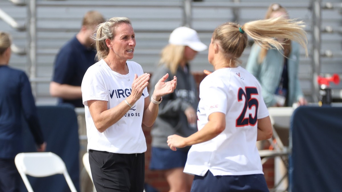 Virginia women's lacrosse head coach Julie Myers claps from the sideline during the game against Boston College at Klockner Stadium.