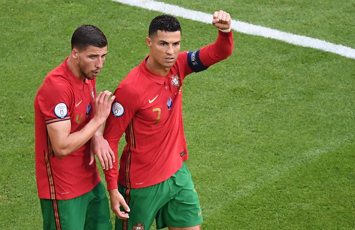 Portugal teammates Ruben Dias (left) and Cristiano Ronaldo pictured during a game in 2021