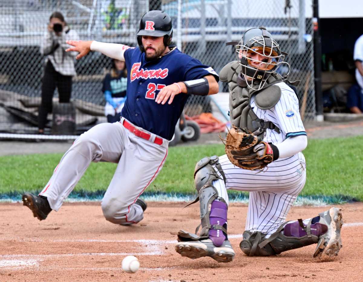 BREWSTER 8/11/22 Evan Sleight of Bourne arrives home as Brewster catcher Kurtis Byrne turns for the throw. Cape League final game Bourne At Brewster Cape League Final