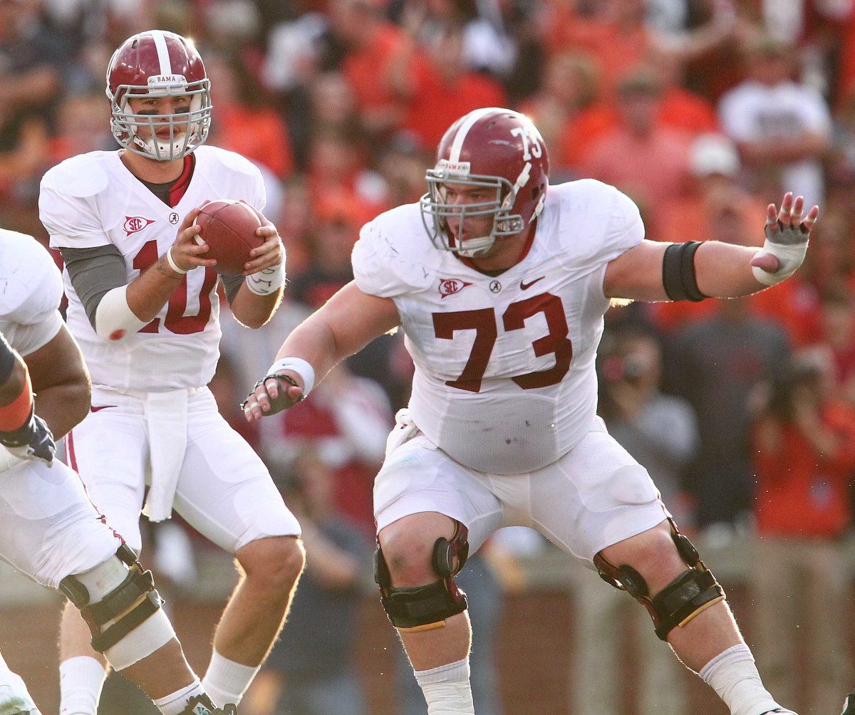 Alabama Crimson Tide quarterback A.J. McCarron (10) takes the snap from offensive lineman William Vlachos (73) during the game against the Auburn Tigers at Jordan-Hare Stadium. The Crimson Tide defeated the Tigers 42-14.