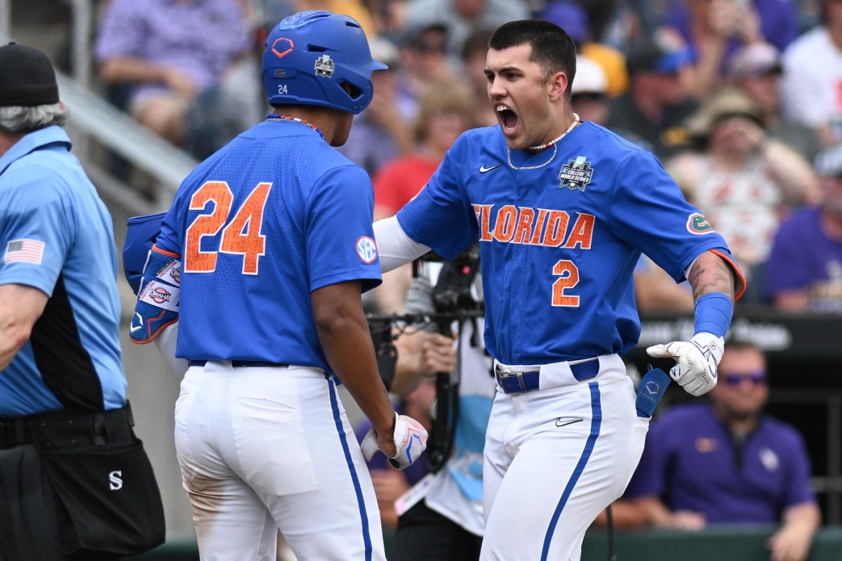 Jun 25, 2023; Omaha, NE, USA; Florida Gators right fielder Ty Evans (2) celebrates with shortstop Josh Rivera (24) after hitting a grand slam home run against the LSU Tigers in the third inning at Charles Schwab Field Omaha.