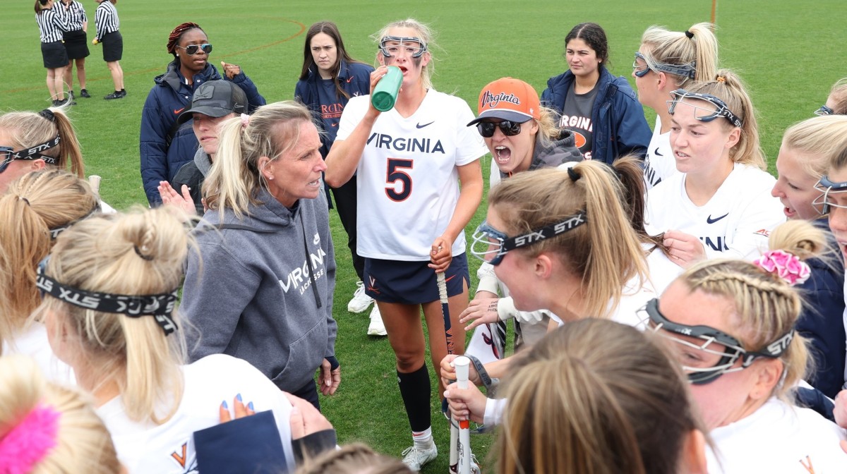 The Virginia women's lacrosse team huddles on the field before a game against Duke at Klockner Stadium.