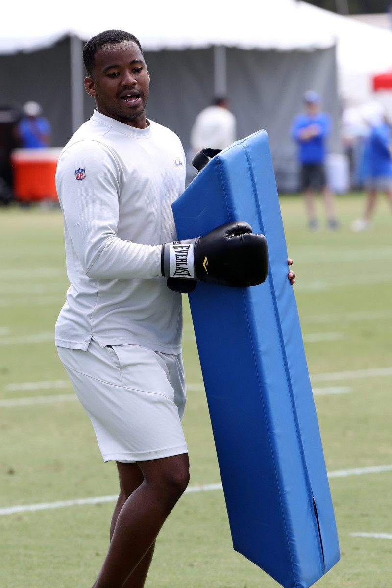 Former Los Angeles Rams running backs coach Ra'Shaad Samples demonstrates a drill