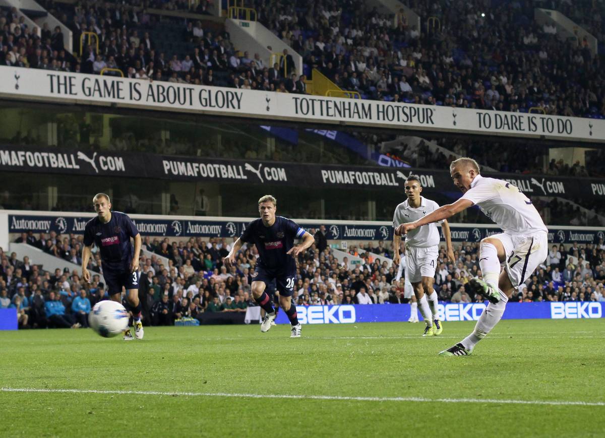 Harry Kane pictured (right) taking a penalty kick on his Tottenham debut in August 2011