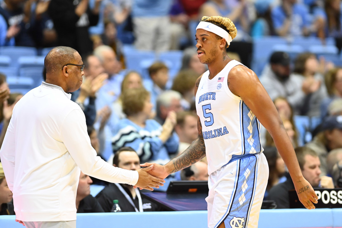 North Carolina F Armando Bacot with North Carolina HC Hubert Davis