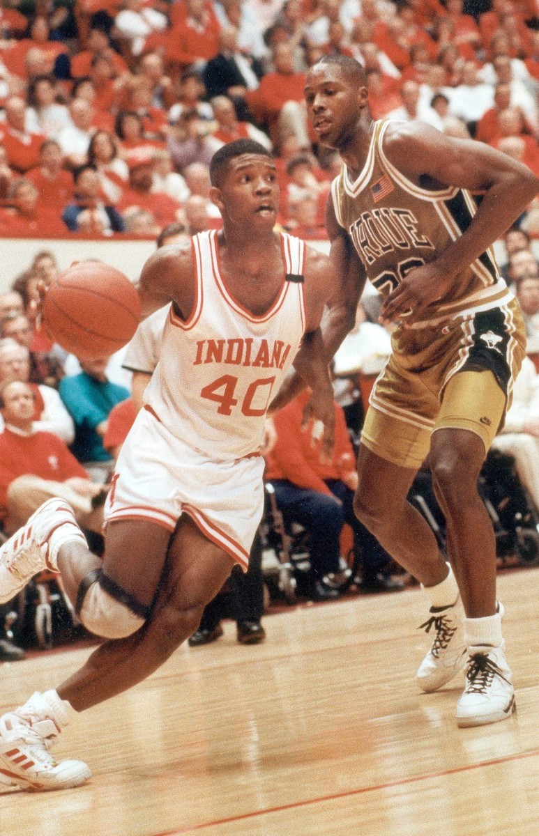 IU's Calbert Cheaney, #40, slides past Purdue's Chuckie White toward two of his 18 points. Feb. 11, 1991.