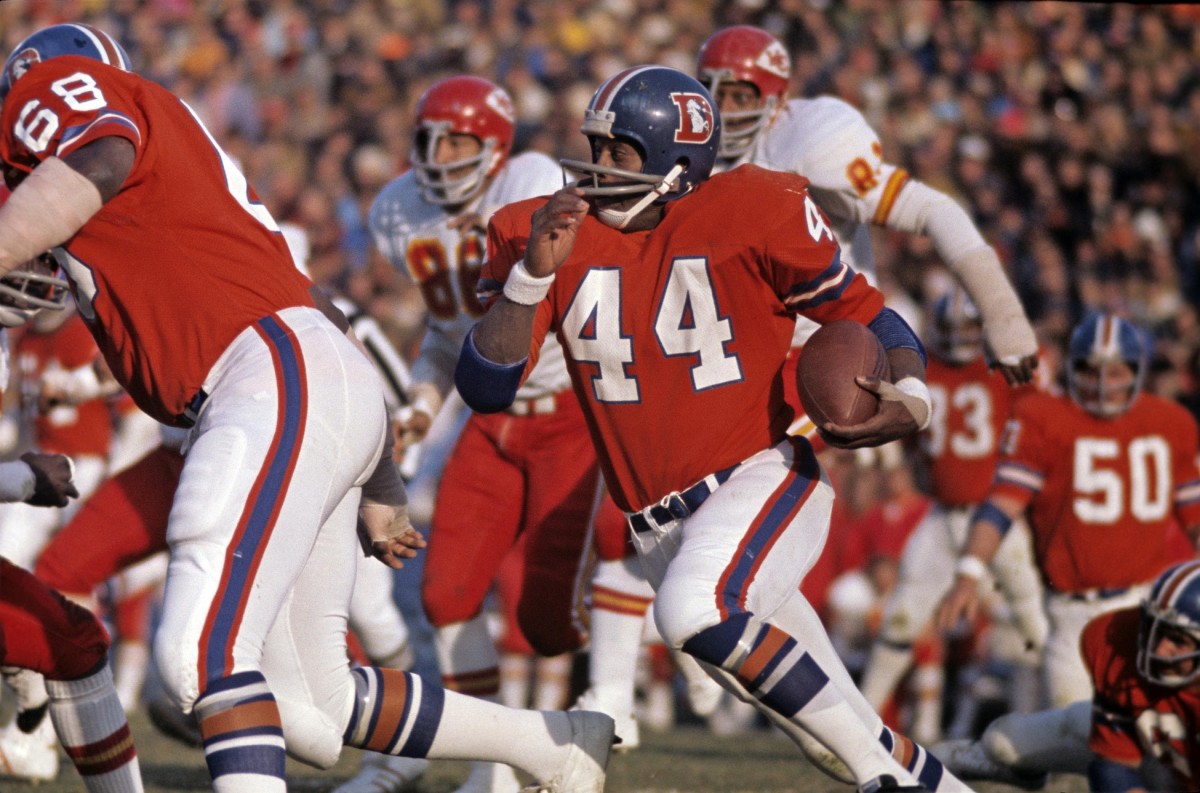 Denver Bronco running back Floyd Little (44) follows the block of guard Larron Jackson (68) as he runs against the Kansas City Chiefs during a game at Mile High Stadium. The Chiefs won, 16-14.