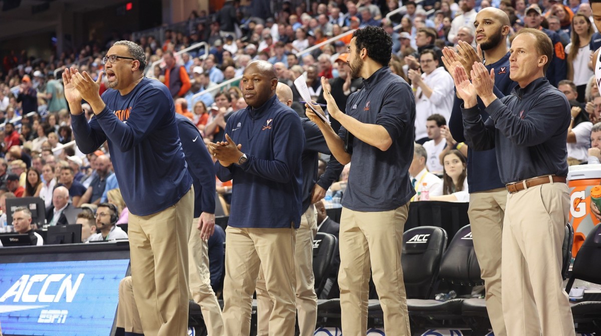The Virginia men's basketball coaching staff reacts from the bench during UVA's game against North Caroline in the quarterfinals of the 2023 ACC Men's Basketball Tournament at Greensboro Coliseum.