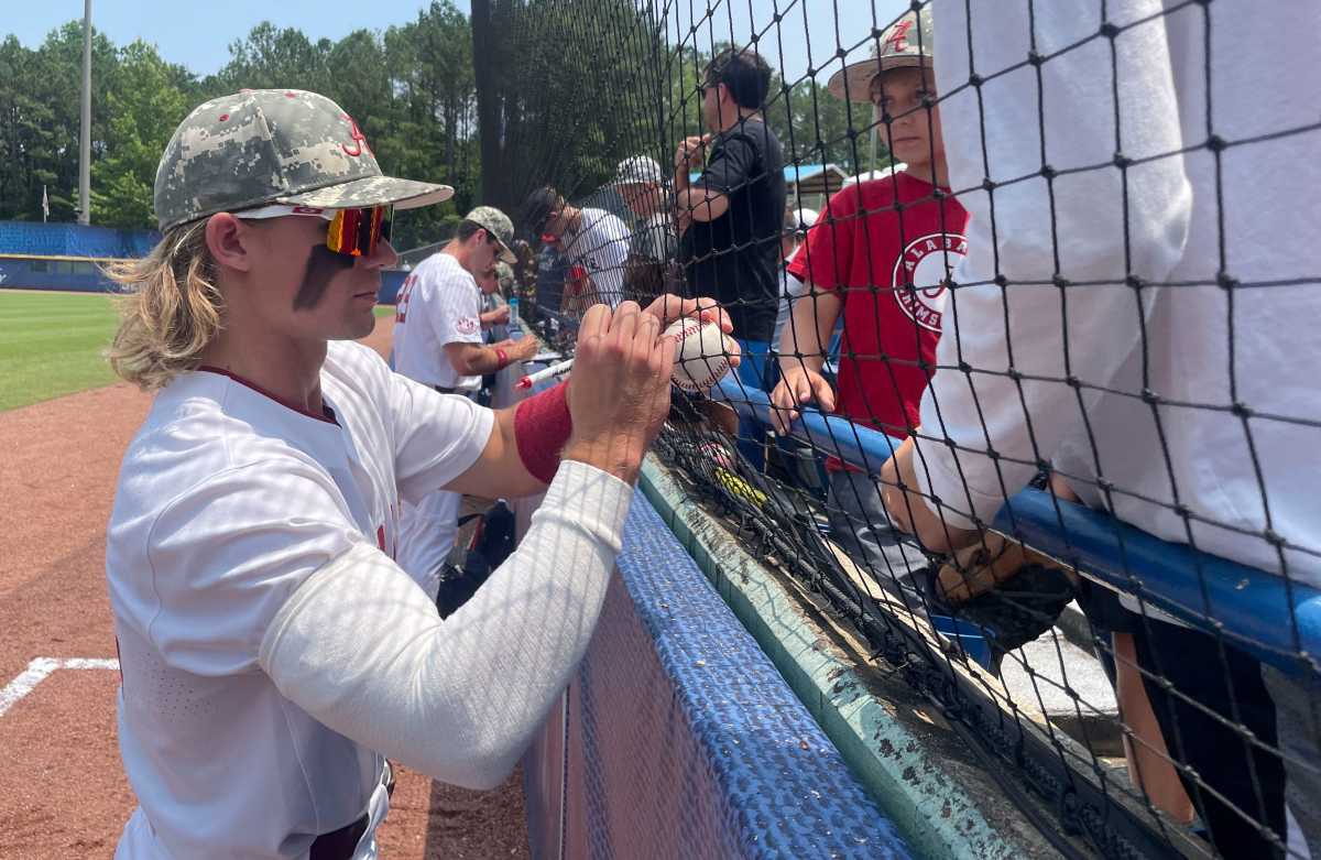 Alabama player Jim Jarvis (10) signs autographs before the SEC Tournament elimination game Thursday, May 25, 2023, at the Hoover Met. Alabama defeated Auburn 7-4 to advance.