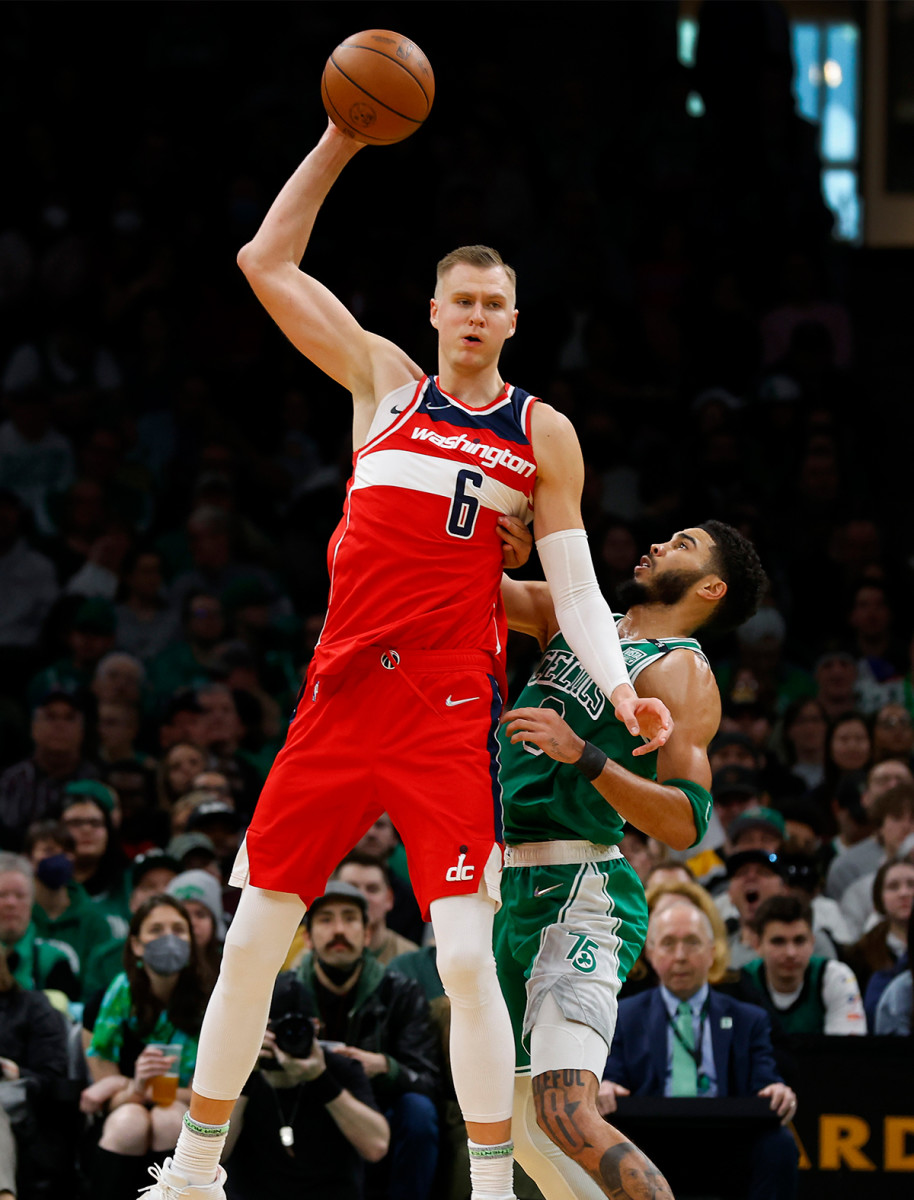 Kristaps Porzingis posts up against Jayson Tatum.