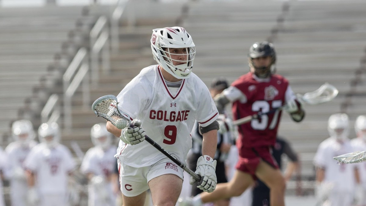 Thomas Colucci cradles the ball after a faceoff win during the Colgate men's lacrosse game against Lafayette.