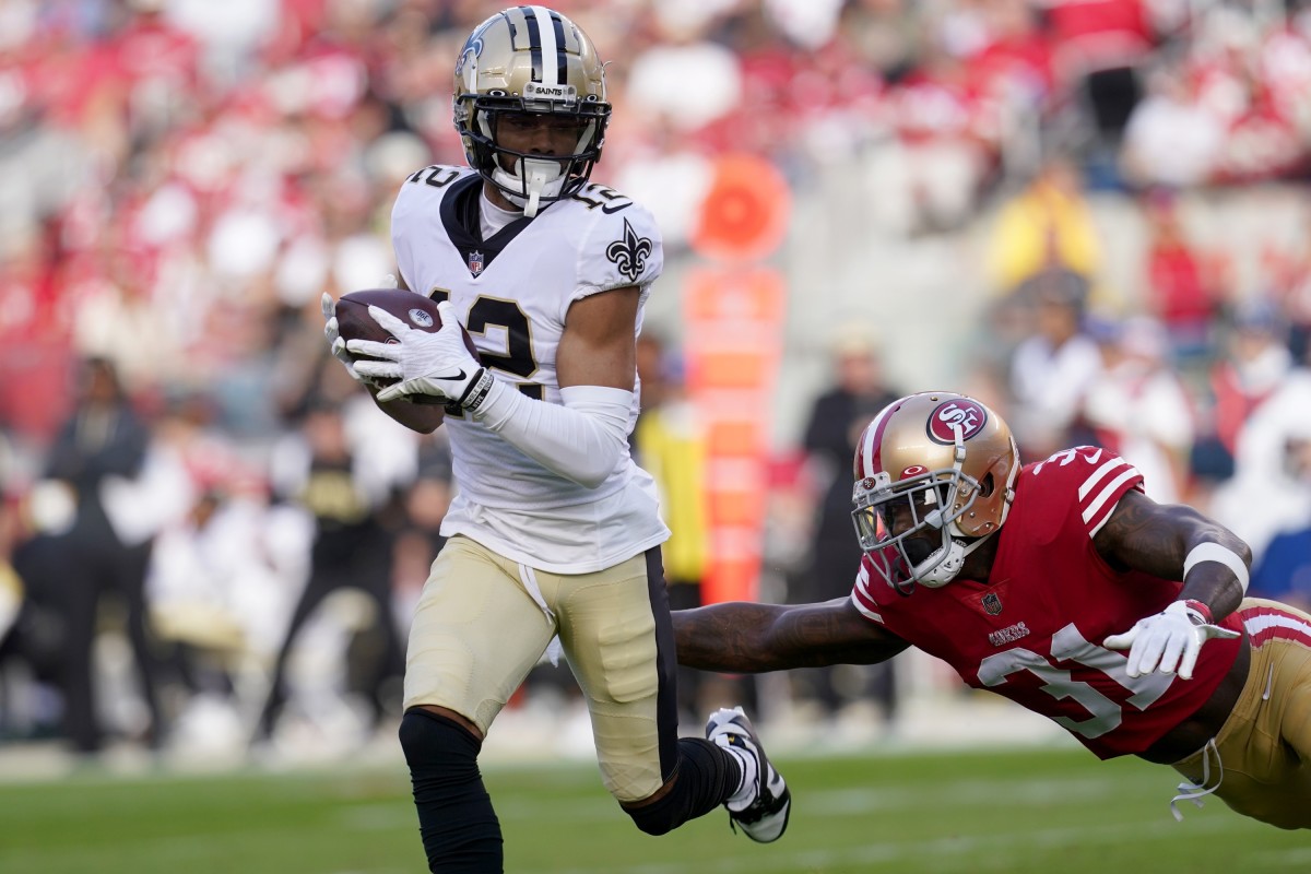 New Orleans Saints receiver Chris Olave (12) runs after a catch against San Francisco 49ers safety Tashaun Gipson Sr. (31). Mandatory Credit: Cary Edmondson-USA TODAY