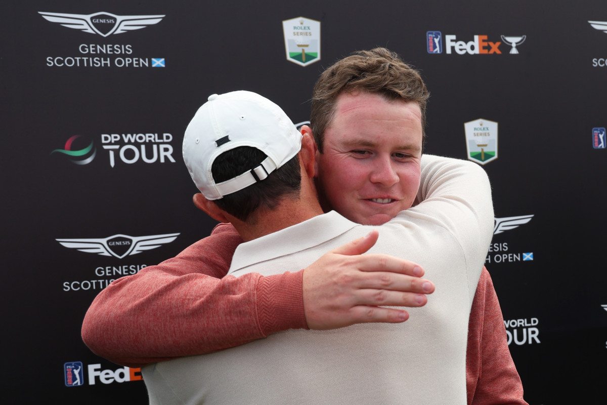 Champion, Rory McIlroy of Northern Ireland and runner-up, Robert MacIntyre of Scotland embrace during Day Four of the Genesis Scottish Open at The Renaissance Club on July 16, 2023 in United Kingdom.