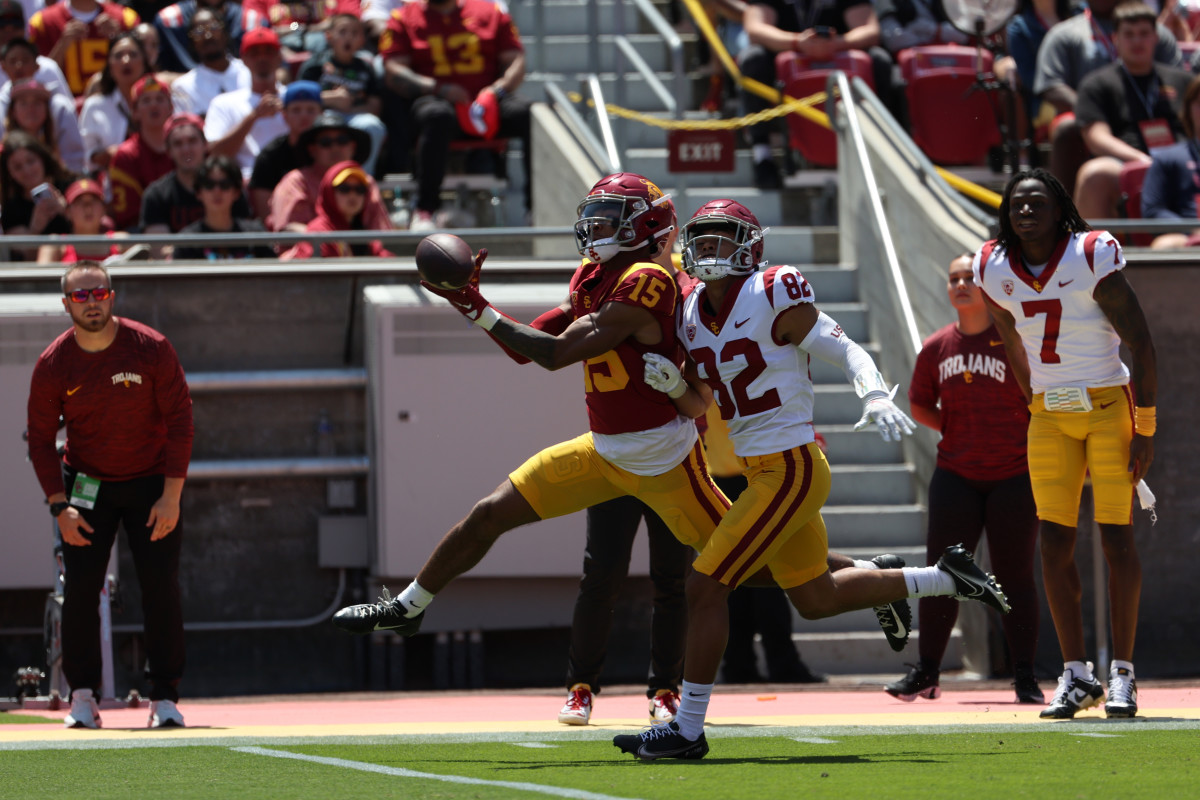 Apr 15, 2023; Los Angeles, CA, USA; USC Trojans wide receiver Dorian Singer (15) and defensive back Vincent Ragsdale (82) fights for the ball during the Spring Game at Los Angeles Memorial Coliseum. Mandatory Credit: Kiyoshi Mio-USA TODAY Sports