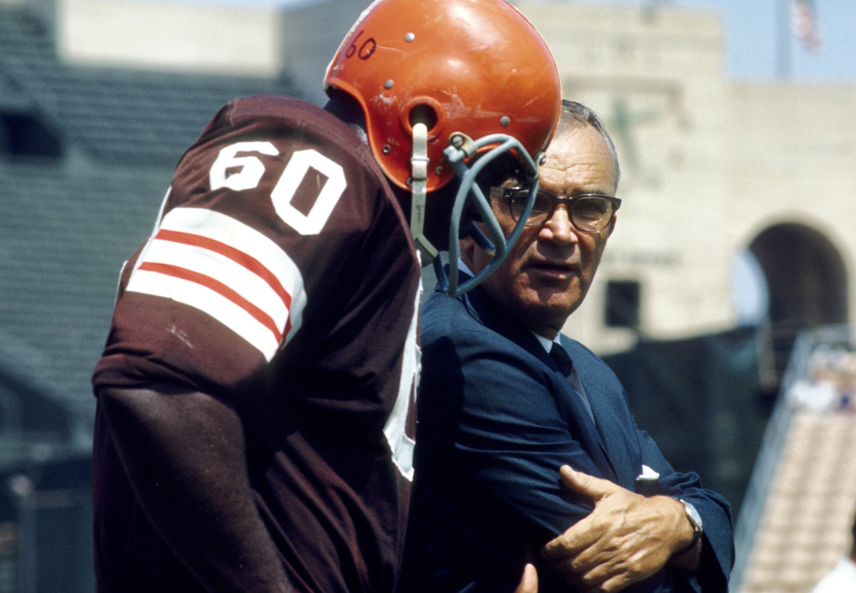 Cleveland Browns head coach Blanton Collier talks to John Wooten (60) on the sideline during a pre-season game against the Los Angeles Rams at the Los Angeles Memorial Coliseum.